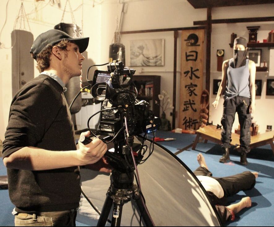 Eric S. Johnsen operating a camera on set.