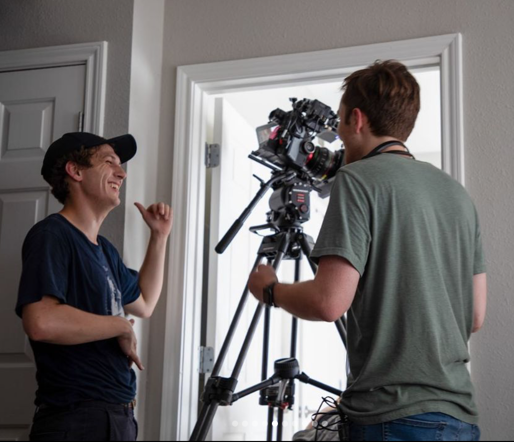 Eric S. Johnsen preparing a camera setup with a collaborator.